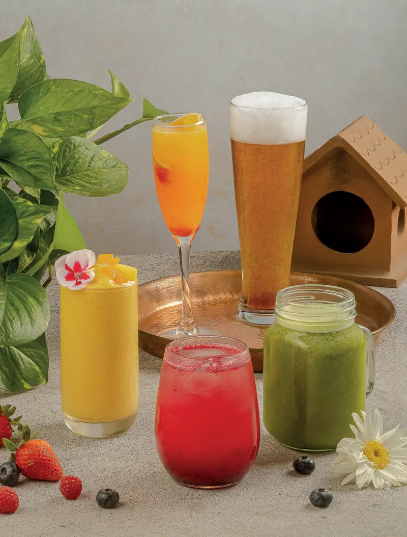 Aperol mimosa, beer, golden mango, strawberry lemonade and green juice on the table