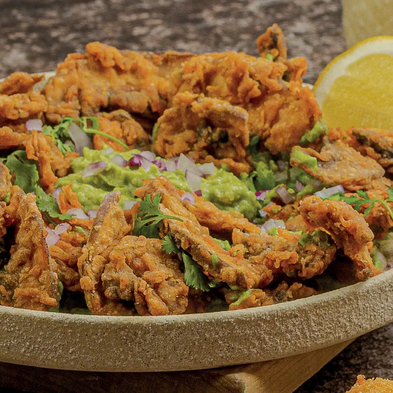 Portobello chicharrón: battered portobello strips with guacamole and red onion