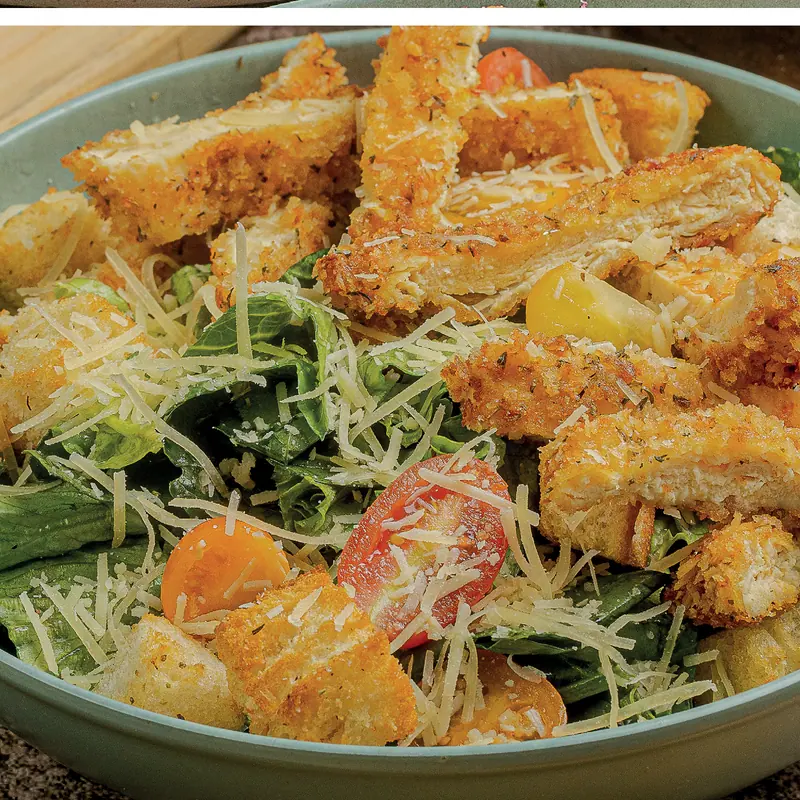 Chicken pesto parm: breaded chicken on Italian lettuce with parmesan and cherry tomatoes