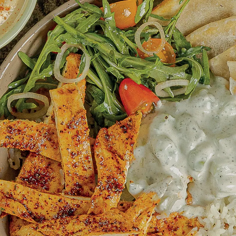 Chicken tzatziki bowl with grilled chicken, rice, arugula and pita bread
