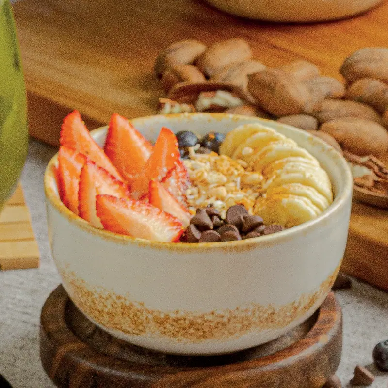Oat and grain bowl with strawberries, banana, blueberries and coconut