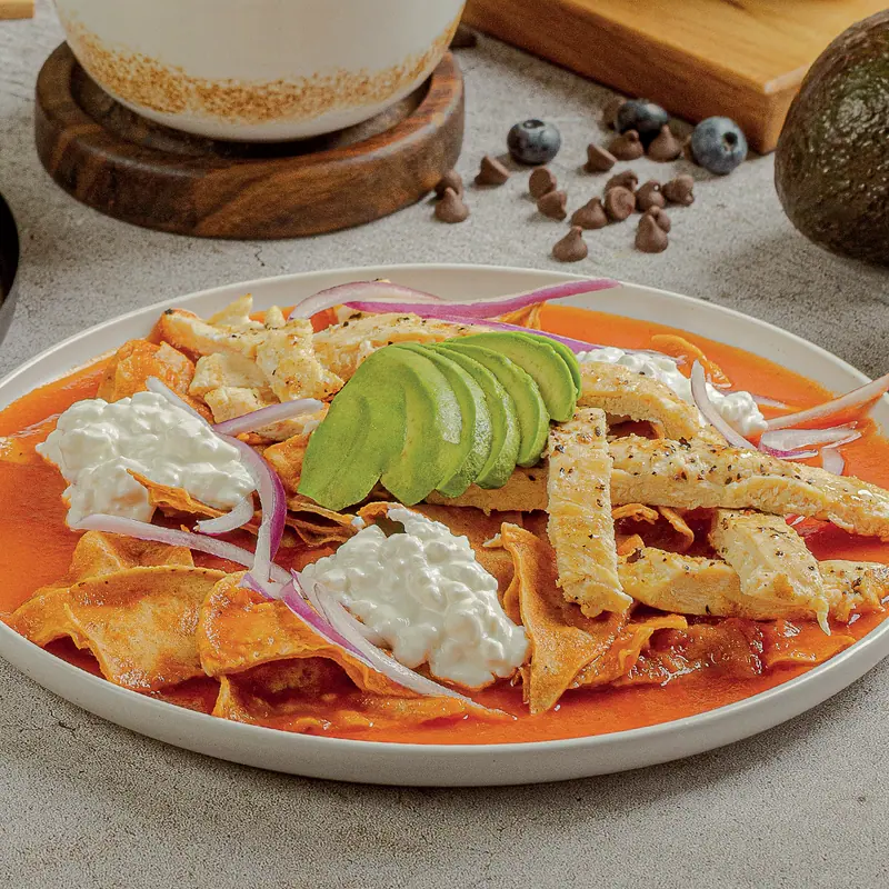 Fit chilaquiles in red salsa with cottage cheese, avocado and red onion