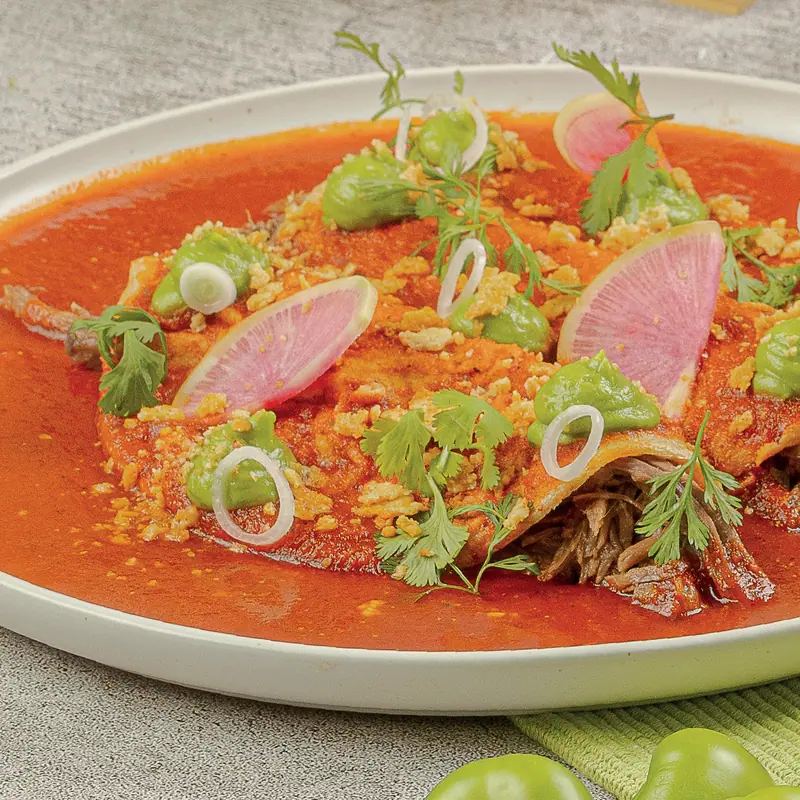 Picaña barbacoa enchiladas in adobo with watermelon radish and onion