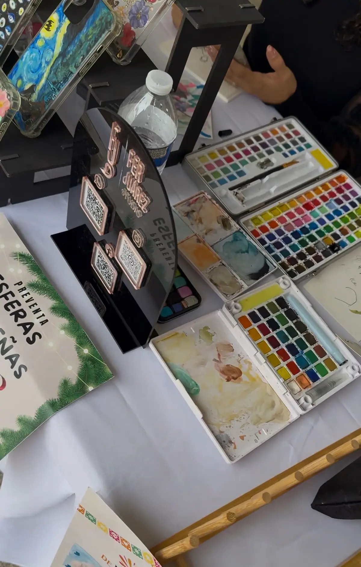 Stand con acuarelas y fundas pintadas a mano